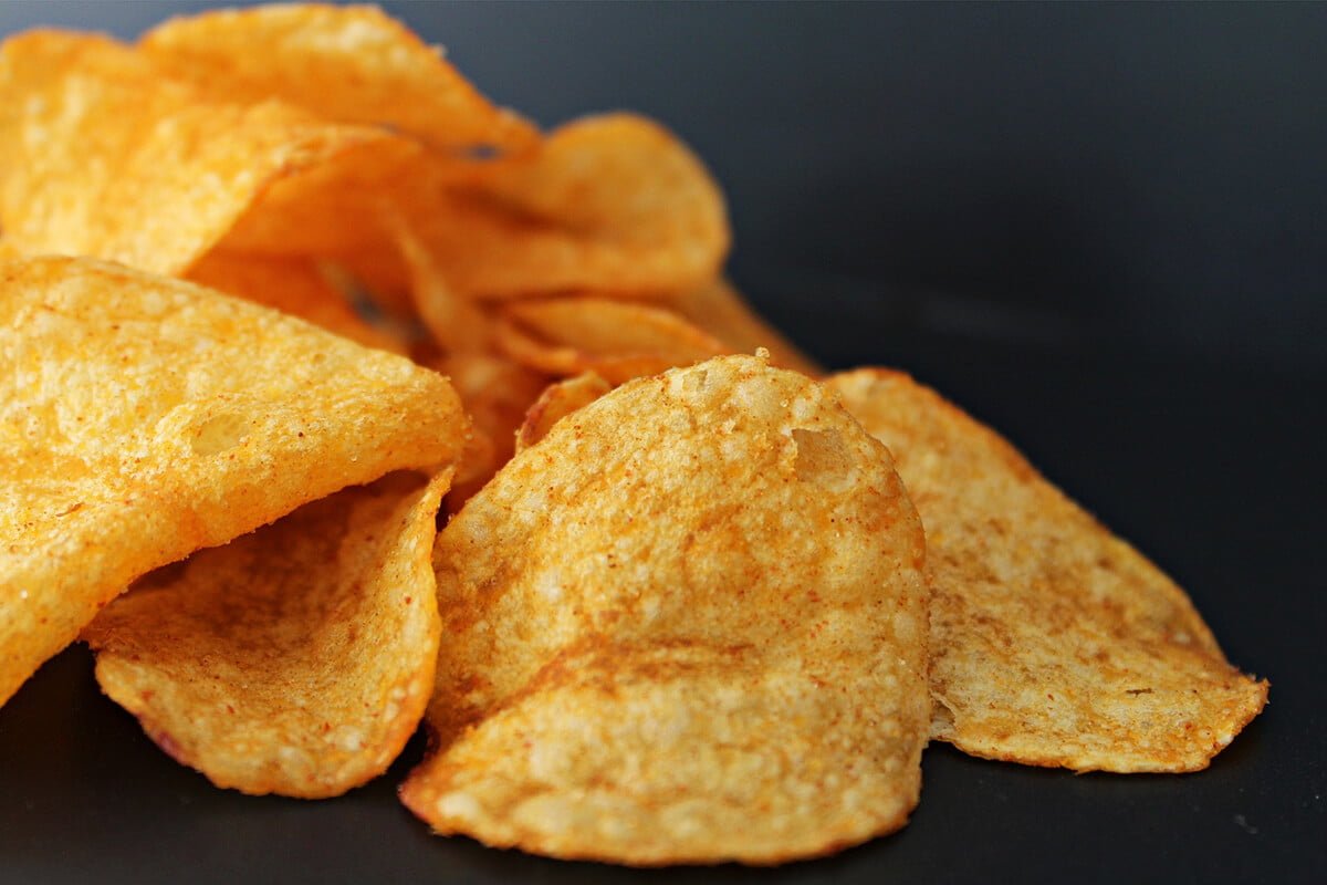 Potato crisps (chips) on dark background